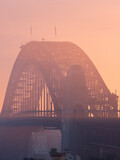 Close-up view of Sydney Harbour Bridge under the morning golden light.