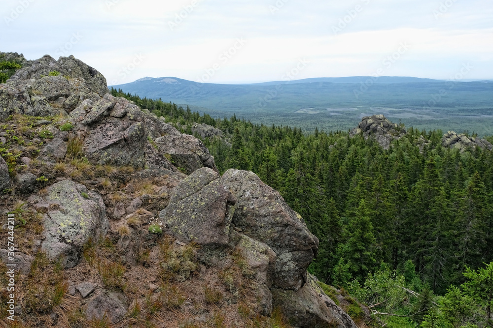 summer landscape in mountains. mountain rocks, slopes of Southern Ural. travel trip backdrop. national Park Taganay, Russia.