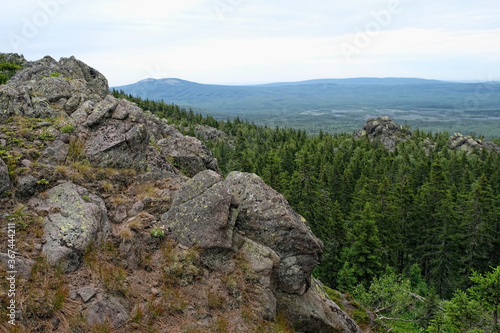 summer landscape in mountains. mountain rocks, slopes of Southern Ural. travel trip backdrop. national Park Taganay, Russia.