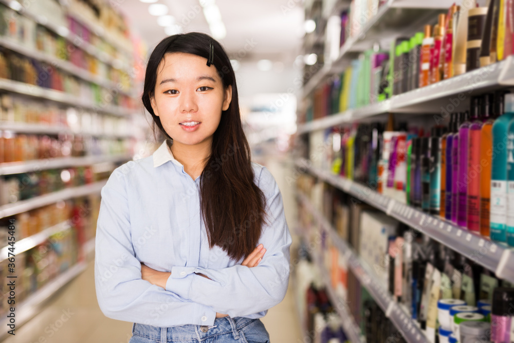 Portrait of cheerful Asian female in cosmetics store