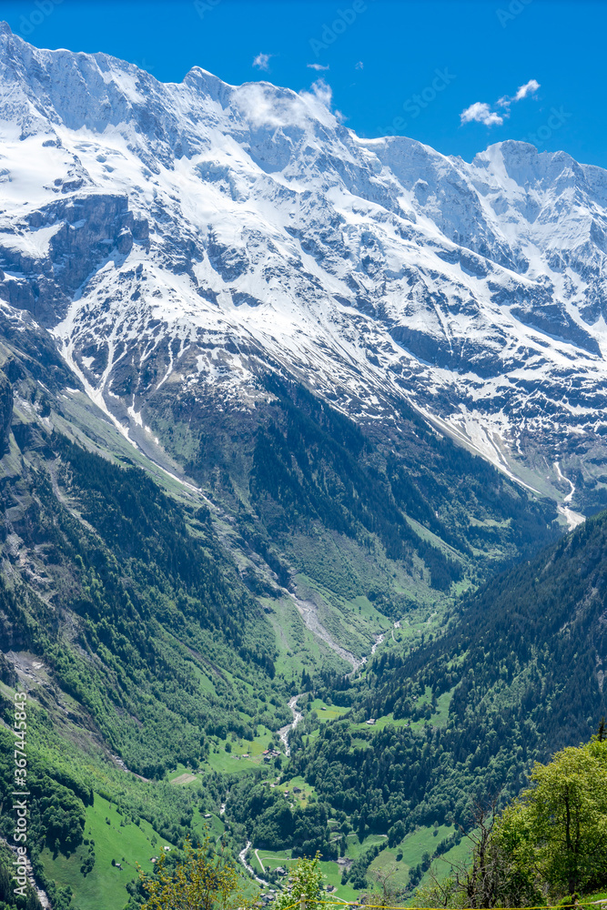 A view of the deep Lauterbrunnen valley and the snow capped peaks above it