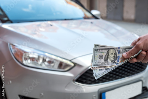 Fototapeta Naklejka Na Ścianę i Meble -  Money to buy the new car. Financial concept