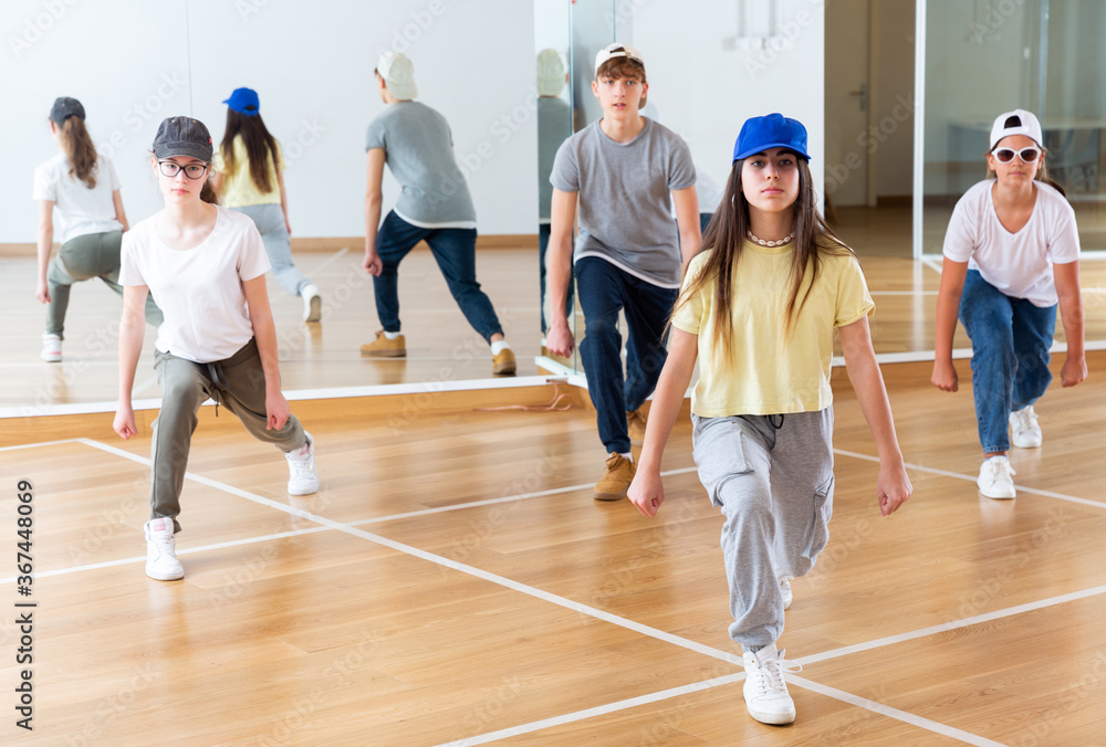 Teenage dance group teaches hip-hop dance in dance studio