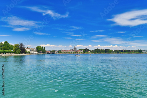 Fototapeta Naklejka Na Ścianę i Meble -  View of Lake Constance from harbor with old historic buildings in background on sunny day in Konstanz city in Germany