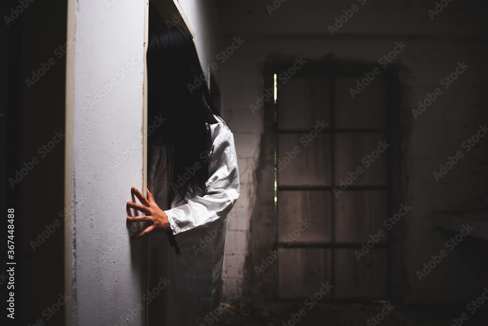 Mysterious Woman, Horror scene of scary ghost woman hiding behind the door of old Abandoned building - obrazy, fototapety, plakaty 
