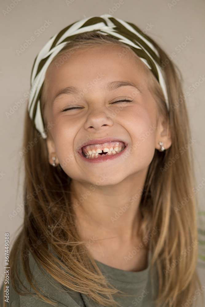 photo of a beautiful toothless brown-eyed girl 6 years old. a child's smile without two lower teeth. Funny close-up portrait of child. Pediatric dentistry. photo of a beautiful toothless brown-eyed girl 6 years old. a child's smile without two lower teeth. Funny close-up portrait of child. Pediatric dentistry.