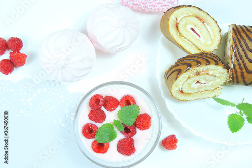 sweet desserts yoghurt with fresh raspberries and mint, marshmallows and tender biscuit with cream, selective focus