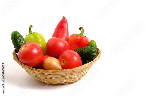 Fototapeta Naklejka Na Ścianę i Meble -  Fresh vegetables sweet bell peppers, cucumbers, tomatoes, onions in basket white background.