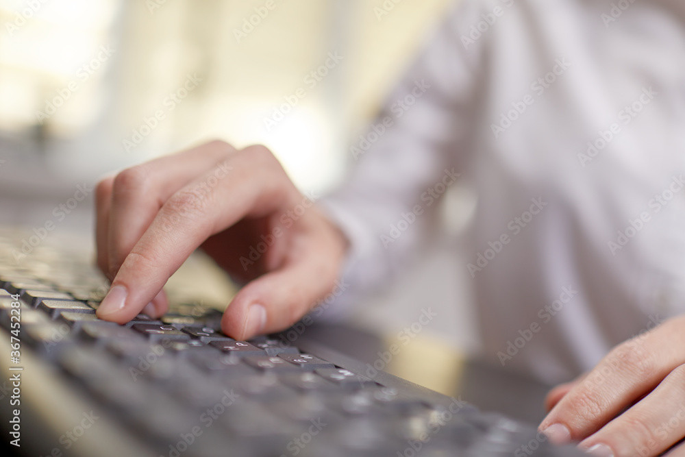 Female hands or woman office worker typing on the keyboard Female hands or woman office worker typing on the keyboard