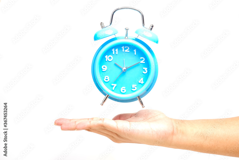 A levitation concept picture of table clock above hand. Time management and success planning concept A levitation concept picture of table clock above hand. Time management and success planning concept