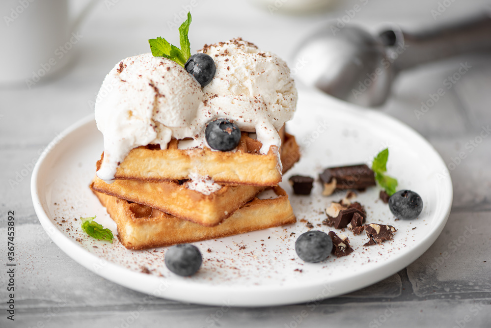 homemade waffles with two scoops of ice cream and chocolate homemade waffles with two scoops of ice cream and chocolate