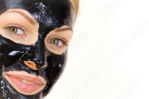 Woman with black peel off mask on face