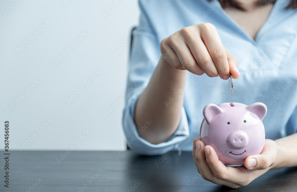 © Lucky7Trader - Woman putting coin into piggy bank, step up start up business to suscess, Saving money for future plan and retirement fund concept