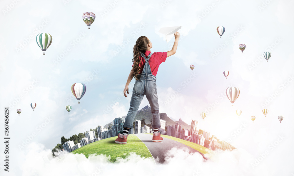 Fototapeta premium Concept of careless happy childhood with girl dreaming about future