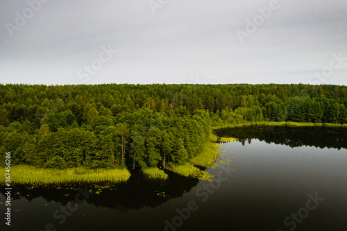 Top view of Bolta lake in the forest in the Braslav lakes National Park at dawn, the most beautiful places in Belarus.An island in the lake.Belarus. photo