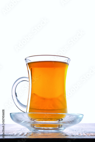 Low angle photo of cup with hot tea with copy space on white background