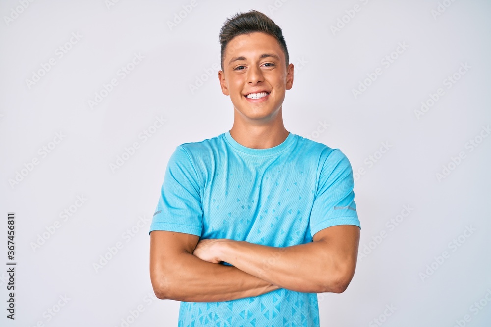 Young hispanic boy wearing casual clothes happy face smiling with crossed arms looking at the camera. positive person.