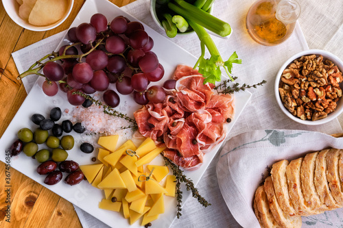 Принти на полотні Overhead view of set of various appetizers for wine - cheese, prosciutto, grape,