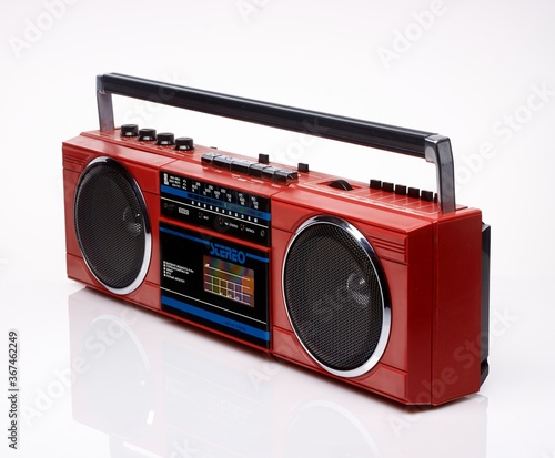 Vintage red boom box on white background with reflection