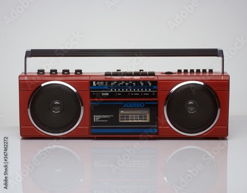 Vintage red boom box on white background with reflection