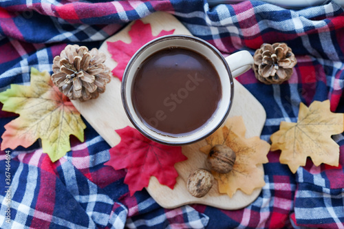 cup of tea with autumn cloth, cones and leaves . autumn mood