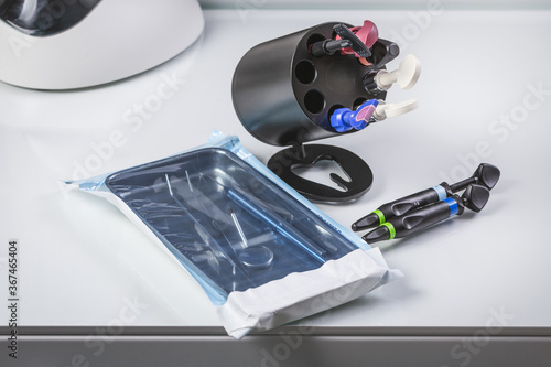 Dental sterile instruments. Furnace for heating composite material. Composite syringes. Closeup, light background.