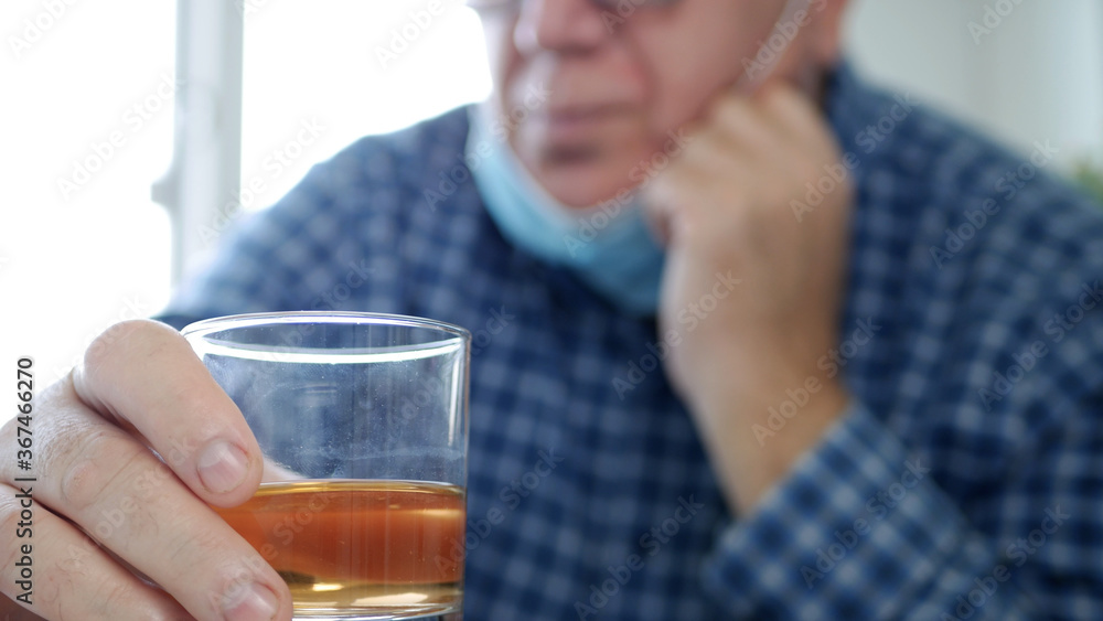 Drunk Person with Protection Mask on His Face Drink a Glass with Alcohol in a Bar Drunk Person with Protection Mask on His Face Drink a Glass with Alcohol in a Bar