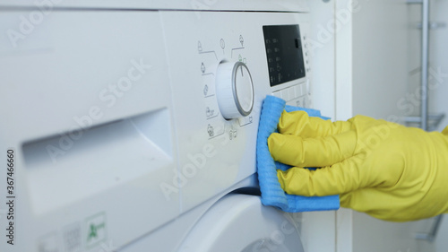 Man Hands Wearing White Protective Household Gloves Cleans and Disinfect the Washing Machine