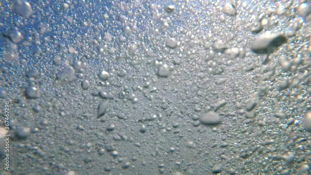 Air bubbles under water. Sunlight and oxygen bubbles in the sea underwater Air bubbles under water. Sunlight and oxygen bubbles in the sea underwater