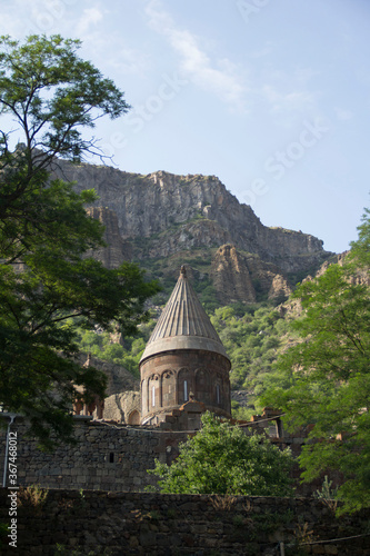  The dome of the Armenian church with a cross among the mountains and trees