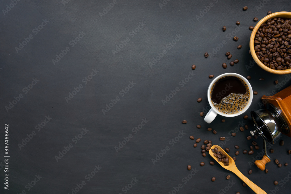 hot coffee and bean on black wooden table background. top view