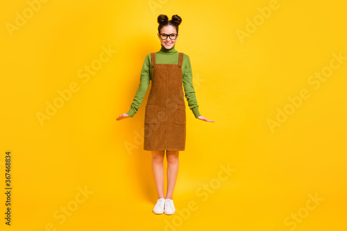 Full size photo of candid satisfied friendly girl look good in camera enjoy weekend wear sweater skirt overall isolated over vivid color background