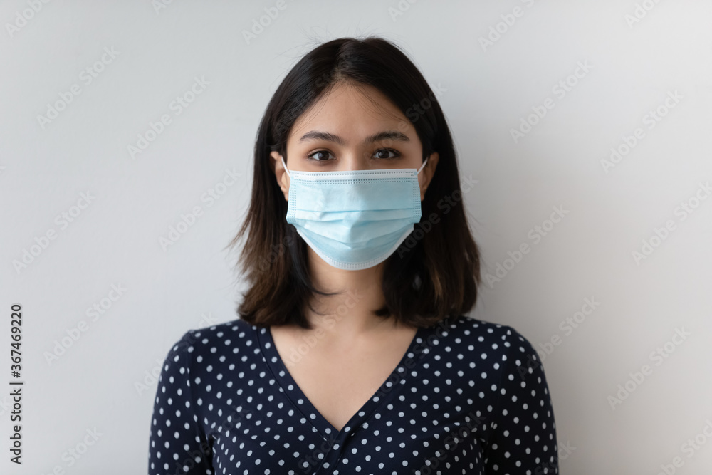 Profile picture of young Vietnamese woman wear protective face mask from covid-19, isolated on grey studio background, headshot portrait of Asian female in medical facial cover, corona virus concept Profile picture of young Vietnamese woman wear protective face mask from covid-19, isolated on grey studio background, headshot portrait of Asian female in medical facial cover, corona virus concept