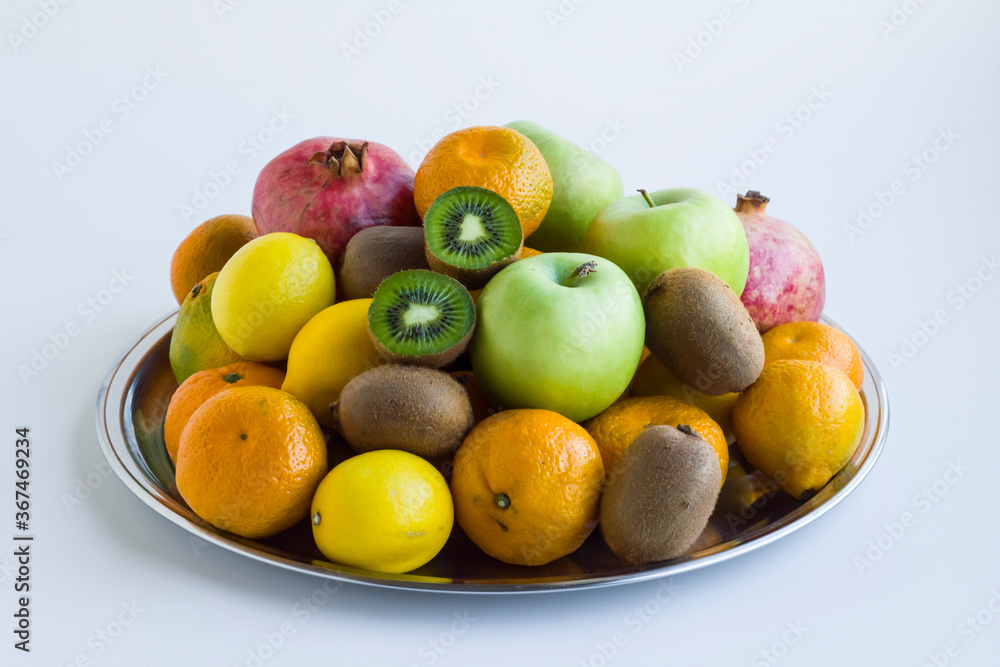 Fresh,ripe group of fruits in metal tray on white,close up Fresh,ripe group of fruits in metal tray on white,close up