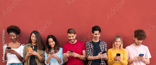 Young people using mobile phones - Millennial friends having fun with new 5g technology trends - Tech and lifestyle concept - Main focus on center faces