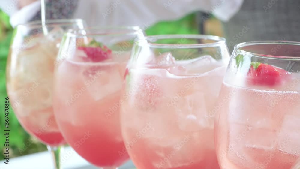 Bartender pours alcohol and strawberries Bartender pours alcohol and strawberries