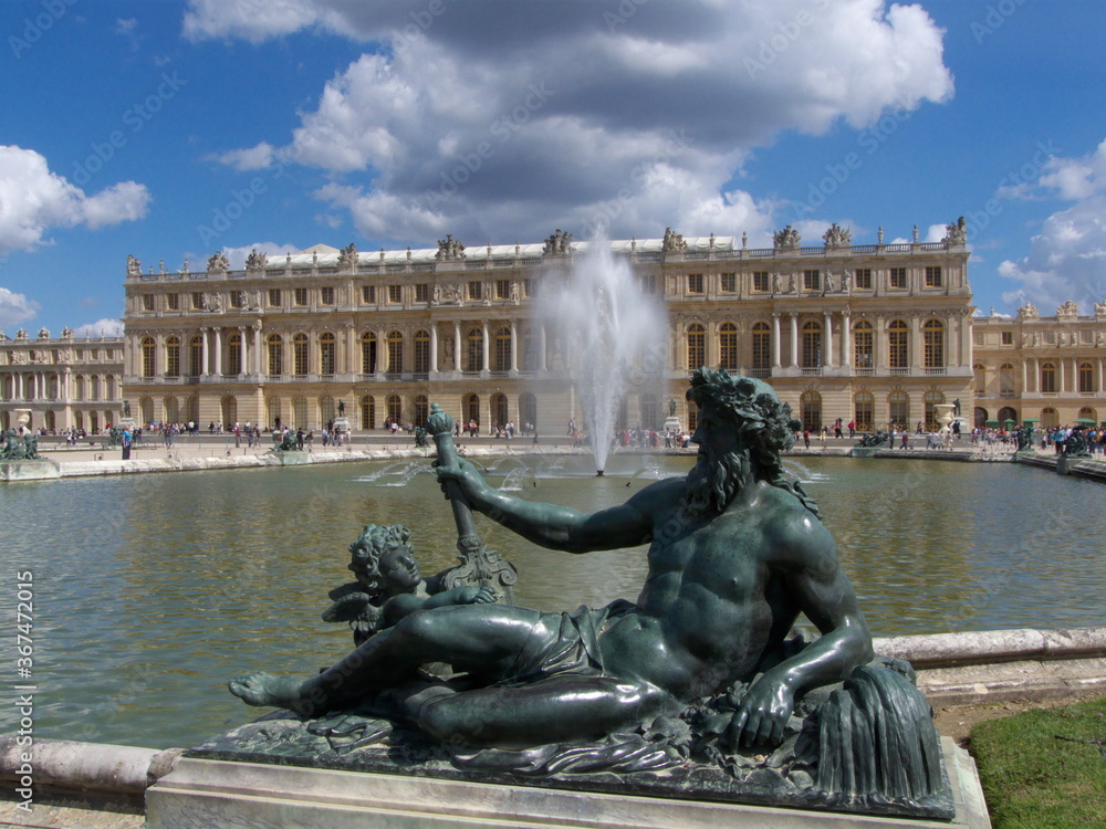 Versailles, France, the palace of Versailles with a beautiful garden in front of facade with a lot of fountains and statues