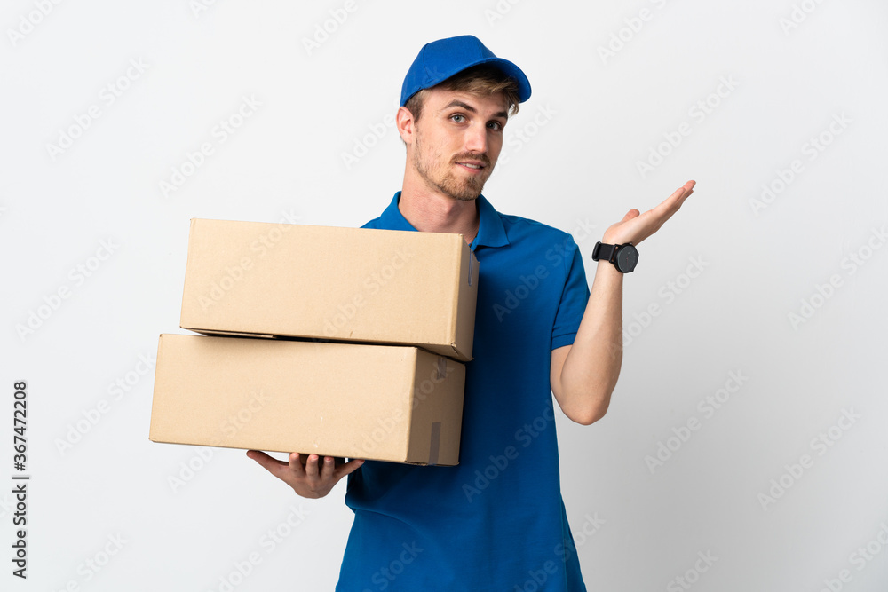 Young delivery blonde man isolated on white background extending hands to the side for inviting to come Young delivery blonde man isolated on white background extending hands to the side for inviting to come