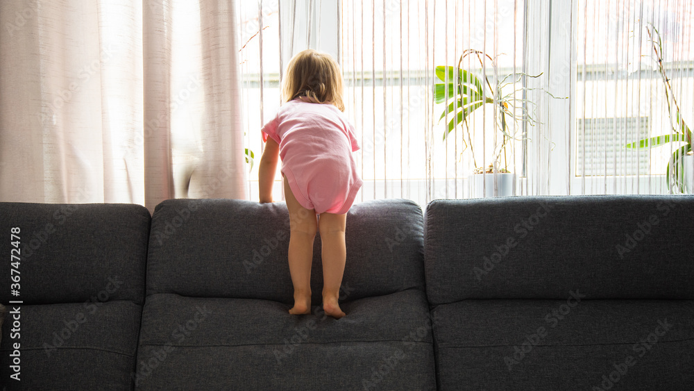 Little baby girl on the sofa at home. copy space Little baby girl on the sofa at home. copy space