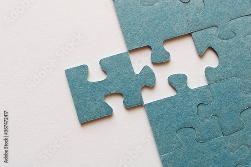 Puzzle. Many puzzle pieces on white background. The concept of collective thinking.