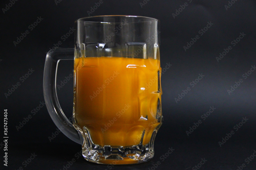 Full glass of orange juice on a black background Full glass of orange juice on a black background
