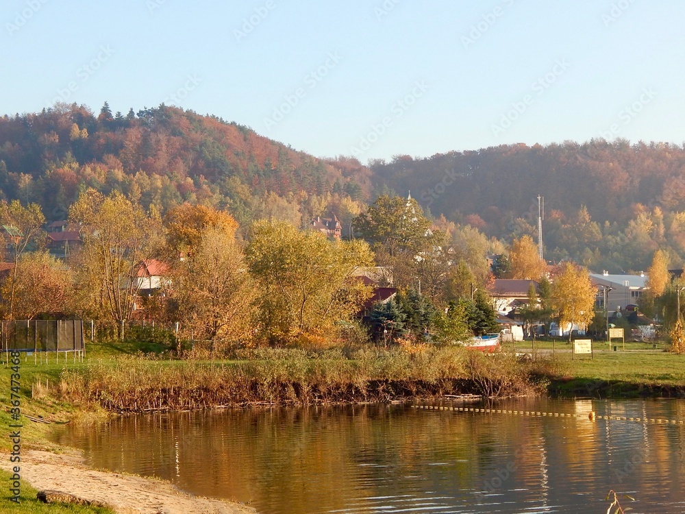 lake on a background of mountains houses and autumn trees lake on a background of mountains houses and autumn trees