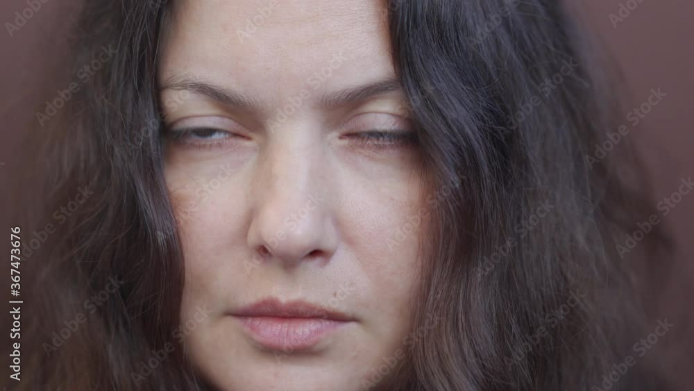 Adult woman portrait on brown background. Close up of brunette woman face. Attractive woman thinking, looking at camera. Female person with long hair beautiful brown eyes. Adult woman portrait on brown background. Close up of brunette woman face. Attractive woman thinking, looking at camera. Female person with long hair beautiful brown eyes.