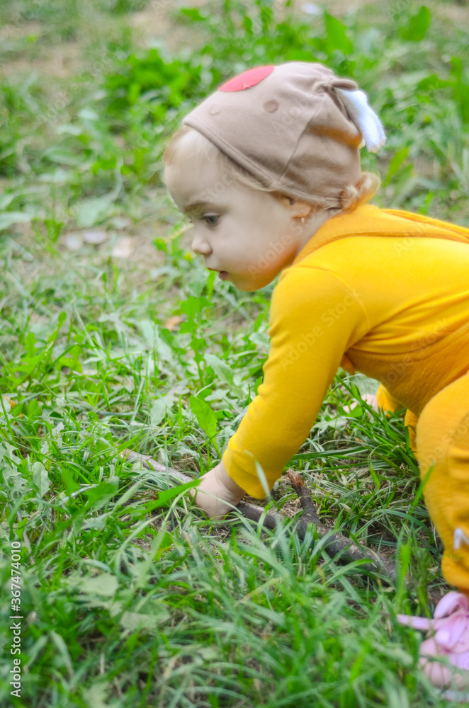 Photo of a blue-eyed toddler girl playing outside on the playground