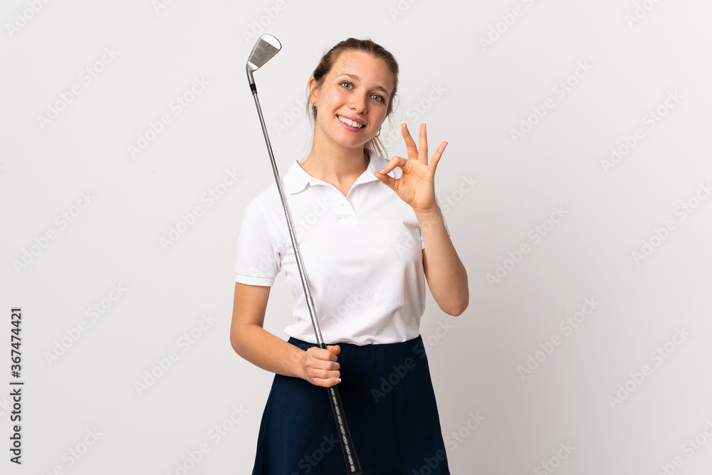 Young golfer woman over isolated white background showing an ok sign with fingers Young golfer woman over isolated white background showing an ok sign with fingers