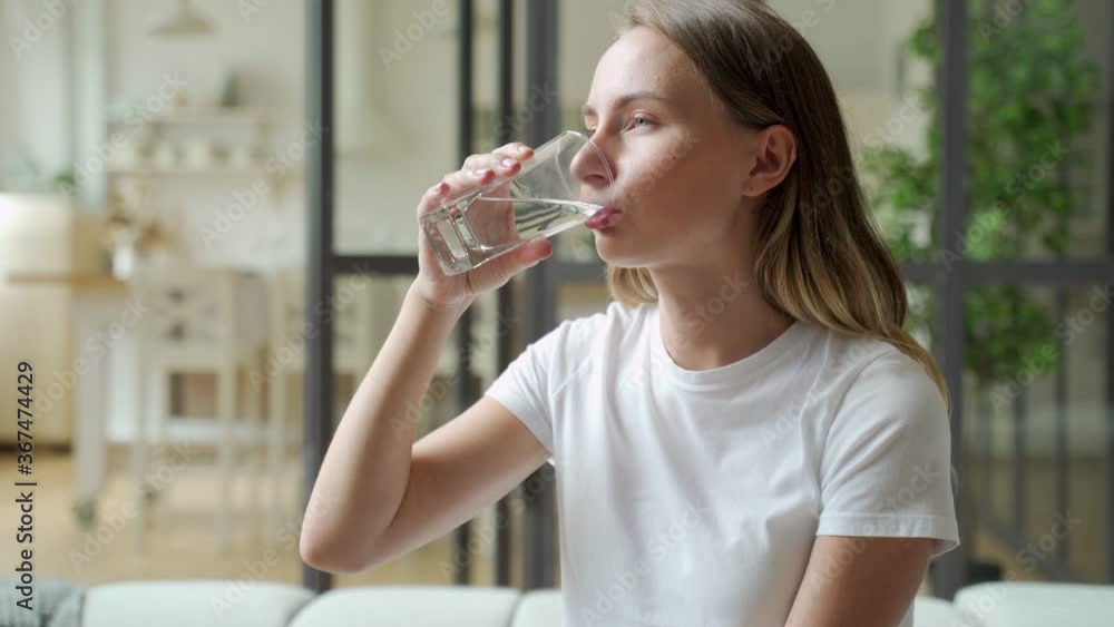 Female drinking from a glass of water. Health care concept photo, lifestyle, close up Female drinking from a glass of water. Health care concept photo, lifestyle, close up