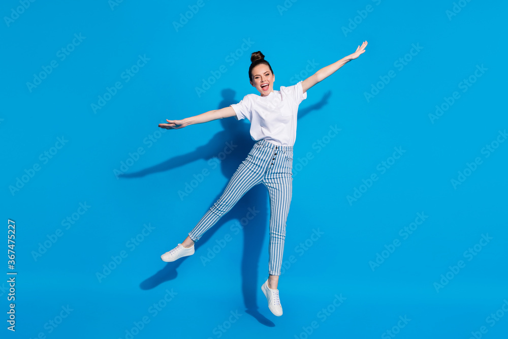 Full size photo of excited enthusiastic cheerful girl jump hold hand enjoy free time weekend wear good look clothes sneakers isolated over bright color background