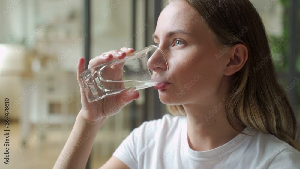 Female drinking from a glass of water. Health care concept photo, lifestyle, close up Female drinking from a glass of water. Health care concept photo, lifestyle, close up