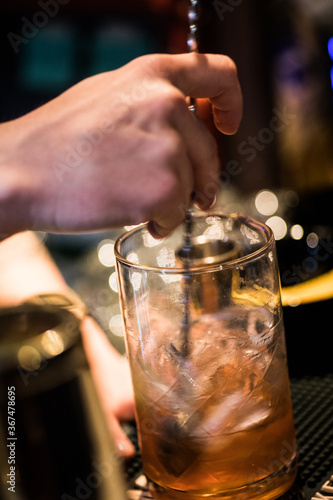 Barman's hand preparing a cocktail