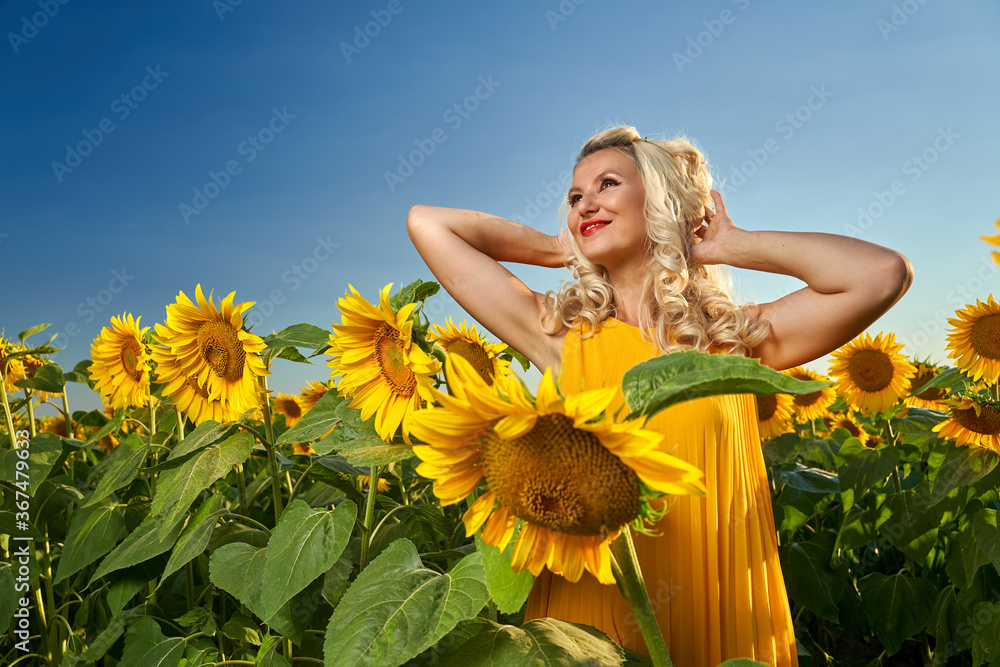 Young attractive woman in a sunflower field Young attractive woman in a sunflower field